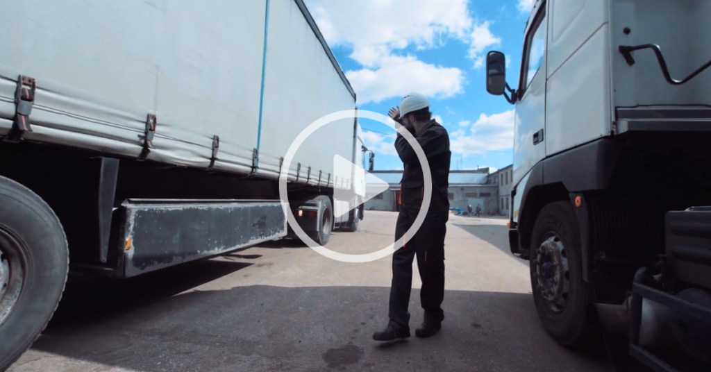 spotter helping truck driver back up, backing problems