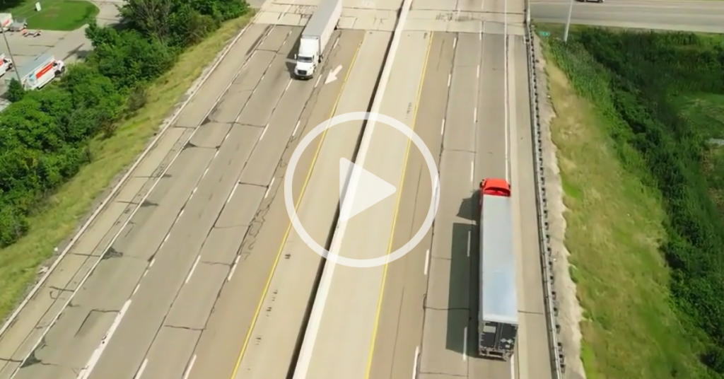 the golden rule of safe driving, aerial view of two semi trucks on interstate