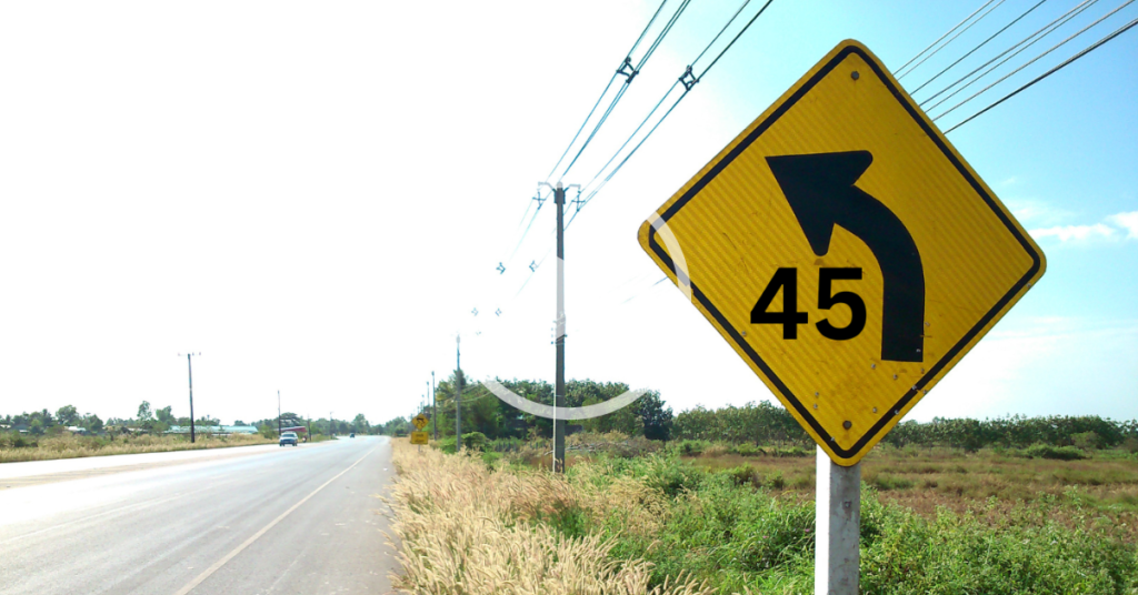 curve ahead warning sign, negotiating curves